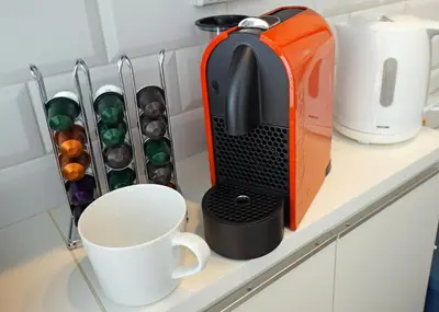 an orange toaster sitting on a shelf with a coffee mug at Stay Well & Give Well, Full Building in Asakusa in Tokyo