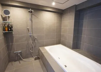 a bathroom with a shower and a bath tub at Stay Well & Give Well, Full Building in Asakusa in Tokyo