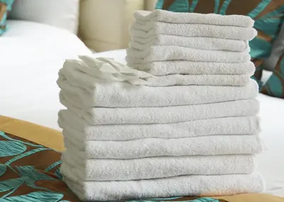a stack of towels sitting on a table at Stay Well & Give Well, Full Building in Asakusa in Tokyo