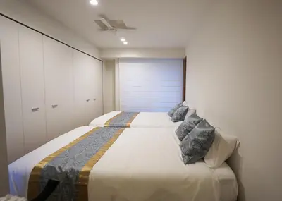 a bedroom with a large bed with two pillows at Stay Well & Give Well, Full Building in Asakusa in Tokyo
