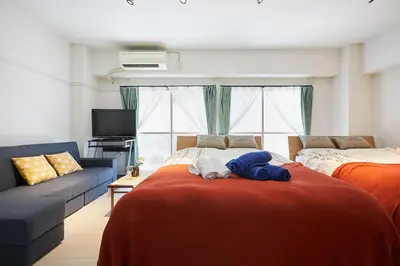 a bedroom with two beds and a blue stuffed animal on a bed at G&R House 102 in Tokyo
