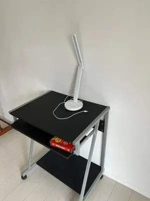 a black desk with a lamp on top of it at G&R House302 in Tokyo