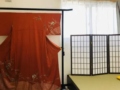 a room with a bed and a curtain and a window at Takara House in Tokyo