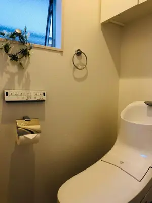 a bathroom with a white toilet and a window at Takara House in Tokyo