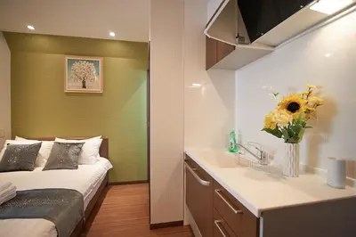 a small bedroom with a bed and a sink at 3 min to Komagome Sta by foot, 15-minute to Shinju, Tokyo station by JR in Tokyo