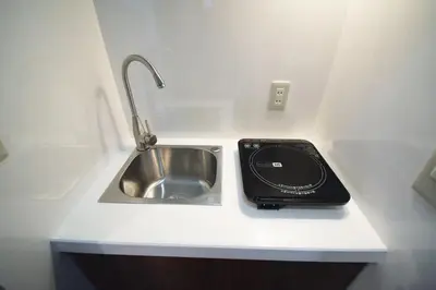 a kitchen counter with a sink and a phone on it at 3 min to Komagome Sta by foot, 15-minute to Shinju, Tokyo station by JR in Tokyo