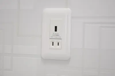 a white electrical outlet on a white wall at Akasaka Urban Hotel Annex in Tokyo