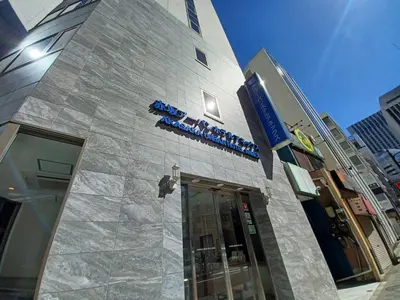 a building with a sign on the side of it at Akasaka Urban Hotel Annex in Tokyo