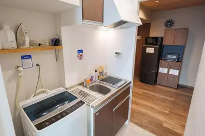 a small kitchen with a sink and a refrigerator at PREMIER suite Shinjuku West 2F in Tokyo