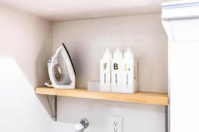 a shelf in a bathroom with bottles on it at PREMIER suite Shinjuku West 2F in Tokyo