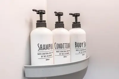 four bottles of shampoo conditioner in a shelf at PREMIER suite Shinjuku West 2F in Tokyo