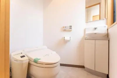 a small bathroom with a toilet and a sink at Minami-Aoyama-1st in Tokyo