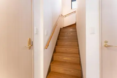 a staircase in a house with wooden floors at Minami-Aoyama-1st in Tokyo