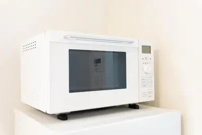 a white microwave sitting on top of a shelf at Minami-Aoyama-1st in Tokyo