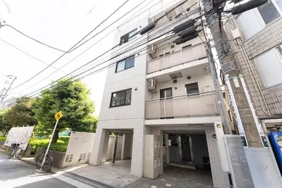 a white building on the side of a street at Minami-Aoyama-1st in Tokyo