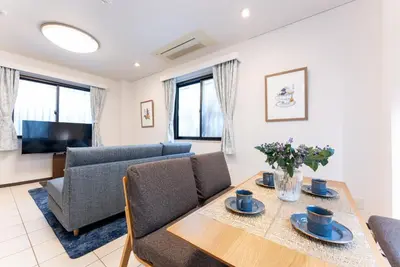 a living room with a table and a couch at Minami-Aoyama-1st in Tokyo