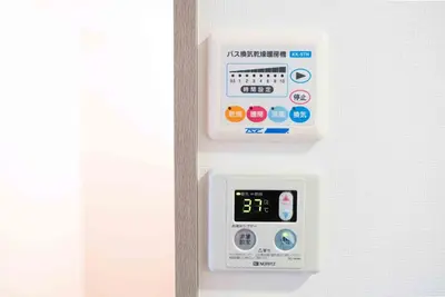 a refrigerator with an electronic clock on the door at MINIMAL SHIMOKITA Stylish Loft or Studio Apt in Tokyo