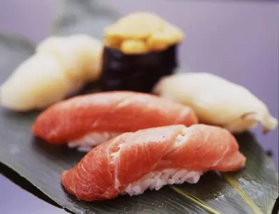three different types of sushi on a cutting board at Imperial Hotel Tokyo in Tokyo