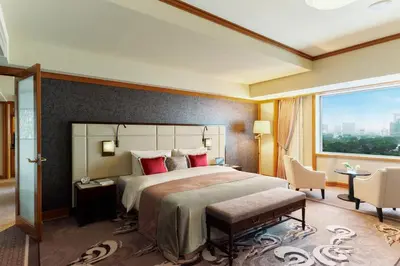 a bedroom with a large bed and a large window at Imperial Hotel Tokyo in Tokyo
