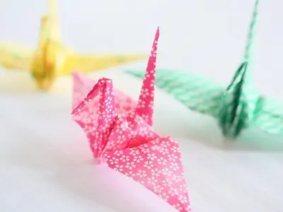 two pink origami umbrellas sitting on a table at APA Hotel Ginza Shintomicho Ekimae in Tokyo
