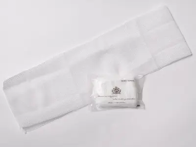 a white shower curtain with a roll of toilet paper at APA Hotel Ginza Shintomicho Ekimae in Tokyo