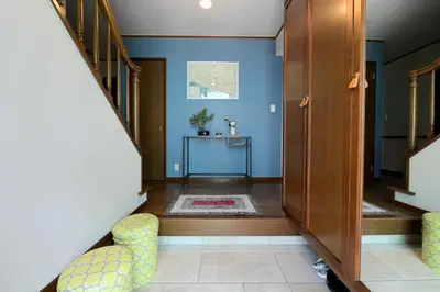 a hallway with blue walls and a staircase with chairs at Nerima-ku - House / Vacation STAY 3889 in Tokyo