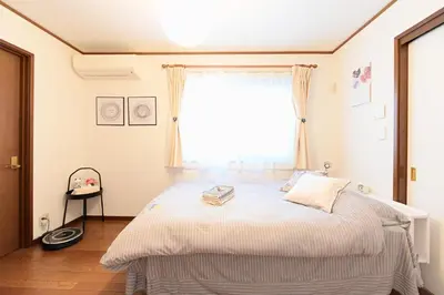 a bedroom with a large bed with a window at Nerima-ku - House / Vacation STAY 3889 in Tokyo