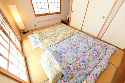 a large bed in a room with flowers on it at Nerima-ku - House / Vacation STAY 3889 in Tokyo