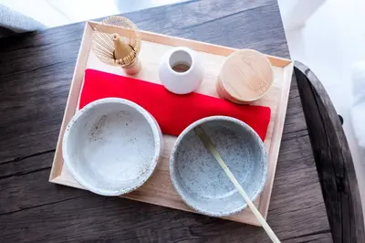 a wooden tray with bowls and chopsticks on a table at NEST HATAGAYA Stylish Apt in Tokyo