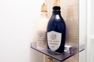 two bottles of wine sitting on a shelf in a refrigerator at NEST HATAGAYA Stylish Apt in Tokyo
