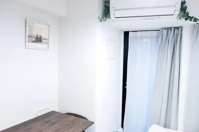 a white room with a window and a table at NEST HATAGAYA Stylish Apt in Tokyo