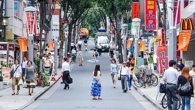 a group of people walking down a busy city street at FINOA Residential Suite Kagurazaka in Tokyo