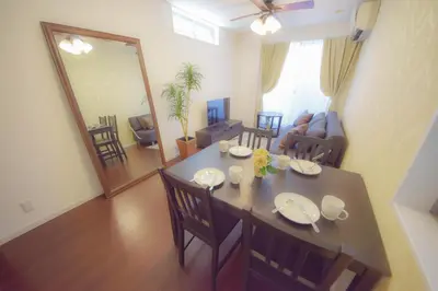 a dining room and living room with a table and chairs at FINOA Residential Suite Kagurazaka in Tokyo