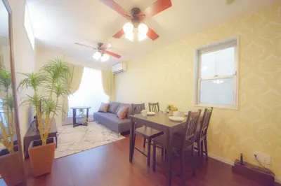 a living room with a table and a couch at FINOA Residential Suite Kagurazaka in Tokyo