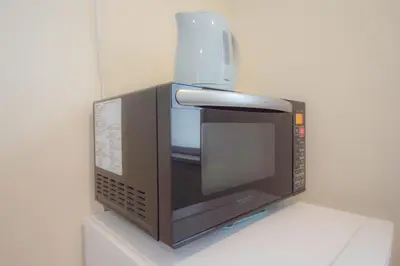 a microwave with a cup on top of it at FINOA Residential Suite Kagurazaka in Tokyo