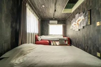 a bedroom with a bed and a laptop in it at K&K Jujo House in Tokyo