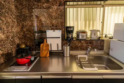 a kitchen with a sink and a counter top at K&K Jujo House in Tokyo