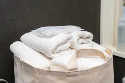 a pile of towels in a trash can at K&K Jujo House in Tokyo
