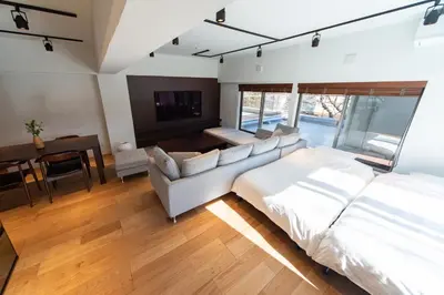 a bedroom with a bed and a couch and a table at NIYS apartments 07 type in Tokyo