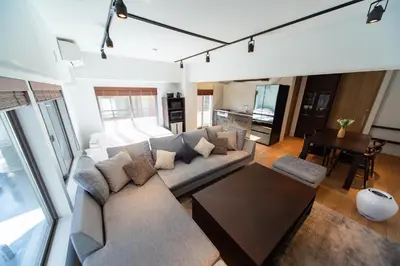 a living room with a couch and a table at NIYS apartments 07 type in Tokyo