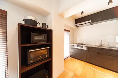 a kitchen with a microwave oven and a stove at NIYS apartments 07 type in Tokyo