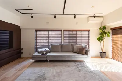 a living room with a couch in a room with windows at NIYS apartments 07 type in Tokyo