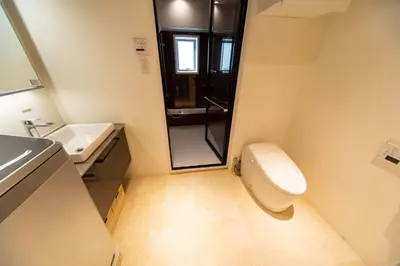 a small bathroom with a toilet and a sink at NIYS apartments 07 type in Tokyo