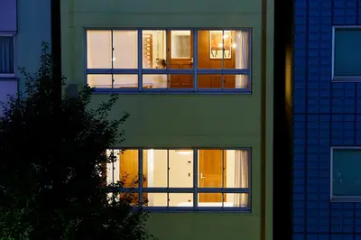 a building with lights in the windows at night at No Service Hotel in Tokyo