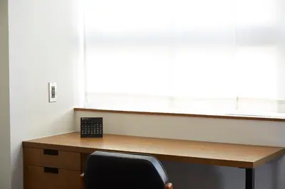 a desk with a chair in front of a window at No Service Hotel in Tokyo
