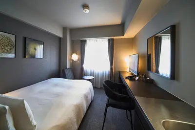 a hotel room with a large bed and a sink at Roppongi Hotel S in Tokyo