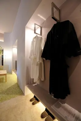 a room with a shelf with a robe and shoes at Roppongi Hotel S in Tokyo