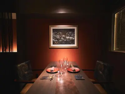 a dining room table with chairs and a picture on the wall at Roppongi Hotel S in Tokyo