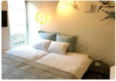 a bedroom with a large white bed with a window at world potential / Vacation STAY 4614 in Tokyo