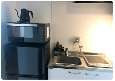 a kitchen with a microwave and a sink at world potential / Vacation STAY 4614 in Tokyo